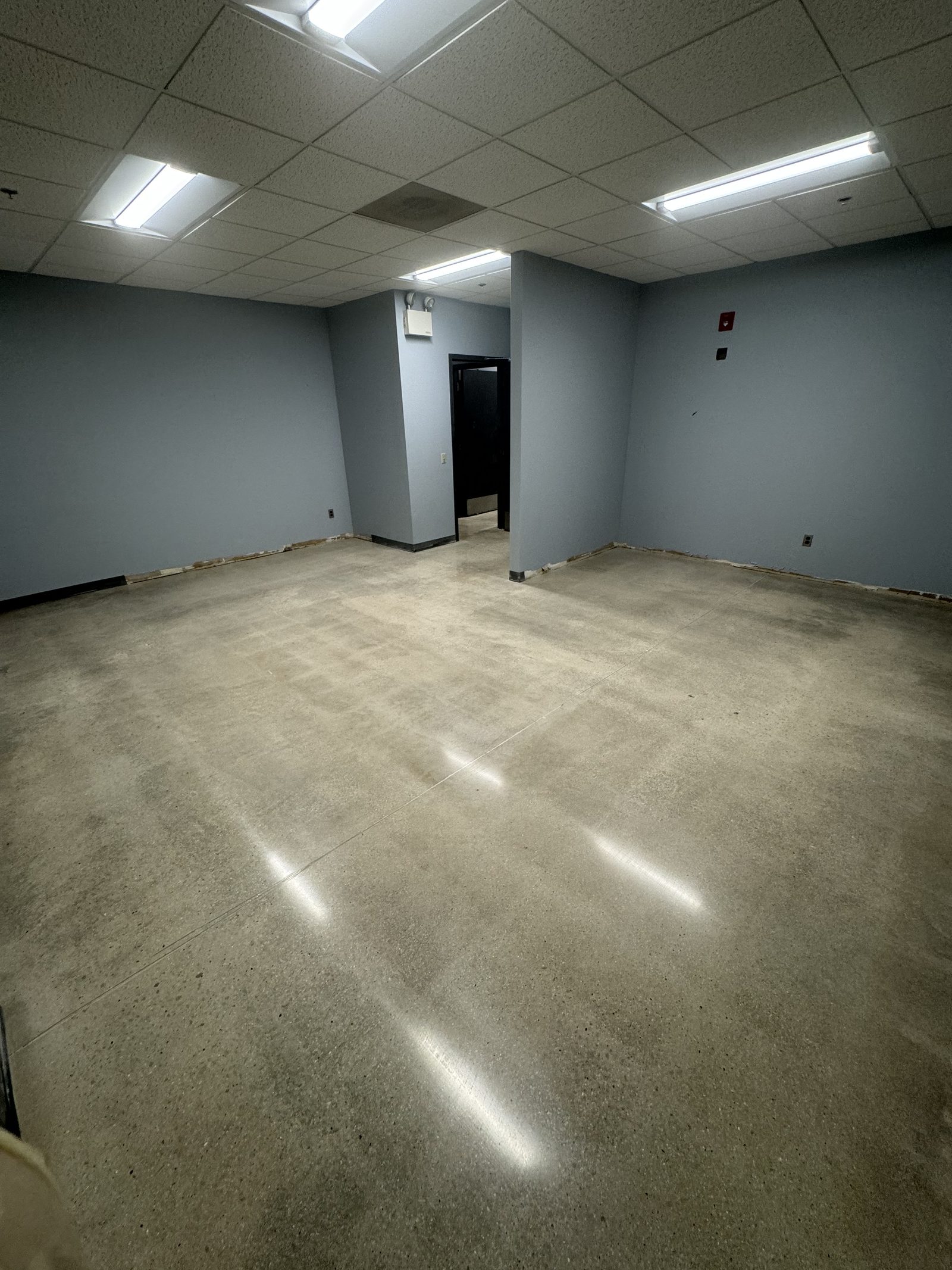 Polished concrete basement floor with reflective finish