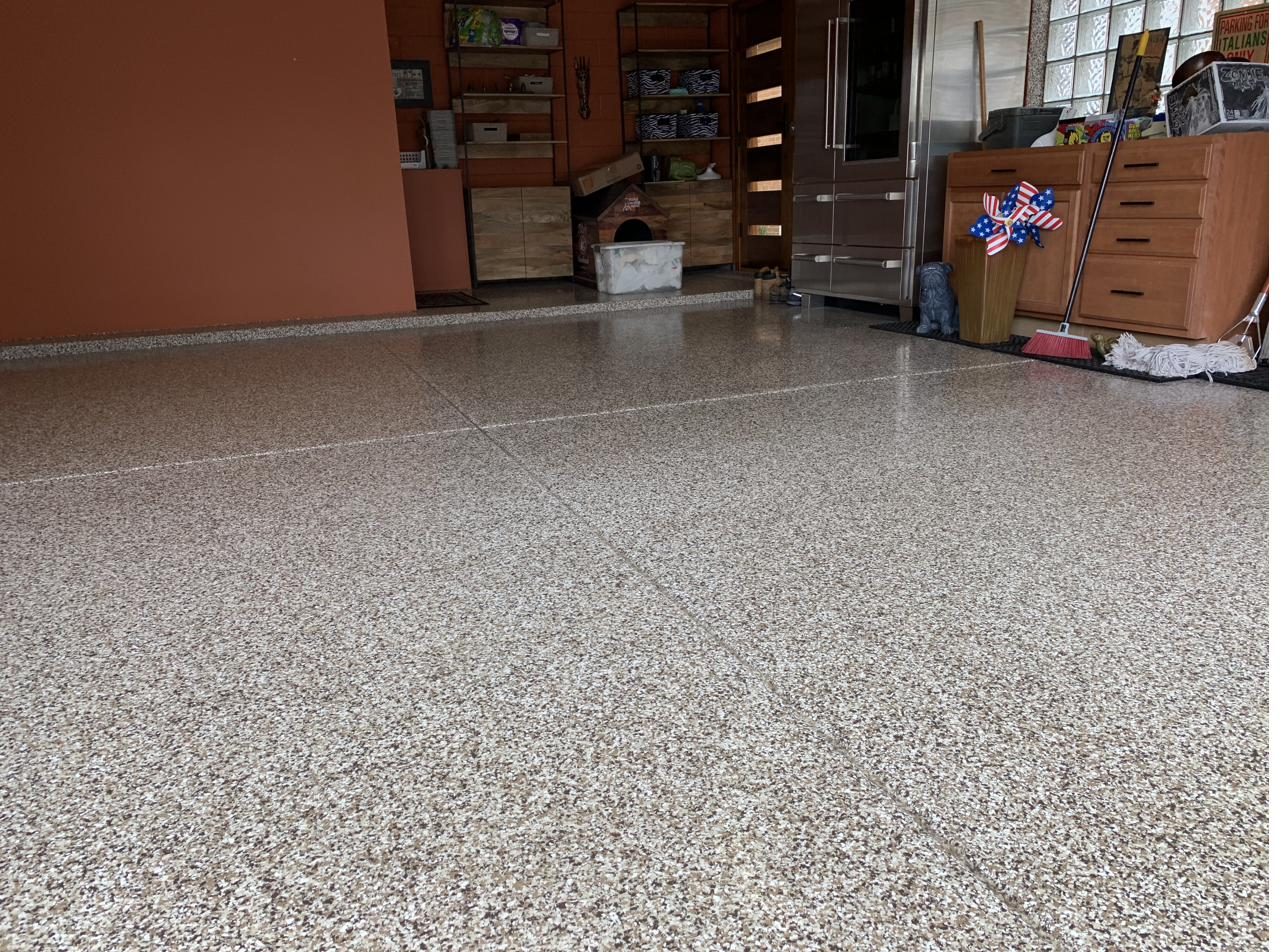 Freshly coated garage floor with tools along the wall
